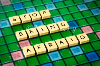 Stop being afraid written with scrabble tiles